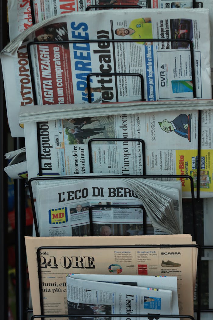 services-04 Stack of Italian newspapers on a street kiosk in Turin, Italy, highlighting daily news.
