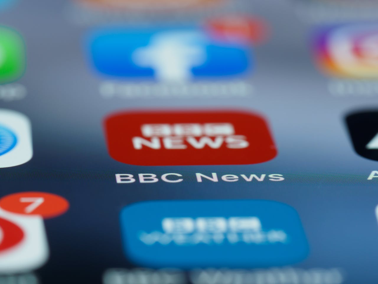 Macro shot of a smartphone screen displaying the BBC News app icon and notifications.